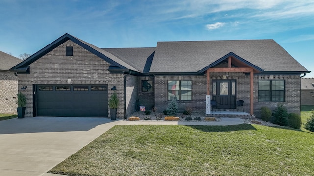 view of front of property featuring a garage, a front yard, concrete driveway, and brick siding