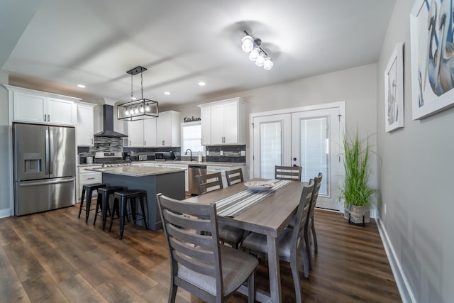 dining room with french doors, dark wood-type flooring, recessed lighting, and baseboards