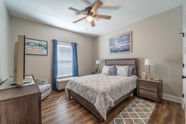 bedroom featuring a ceiling fan, baseboards, and dark wood-type flooring