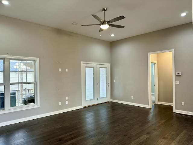 spare room featuring dark wood-style floors, baseboards, a ceiling fan, and recessed lighting