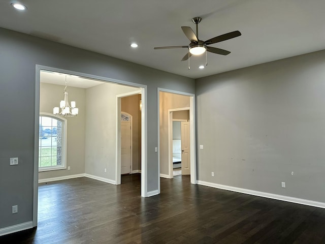 spare room with dark wood-type flooring, recessed lighting, and baseboards