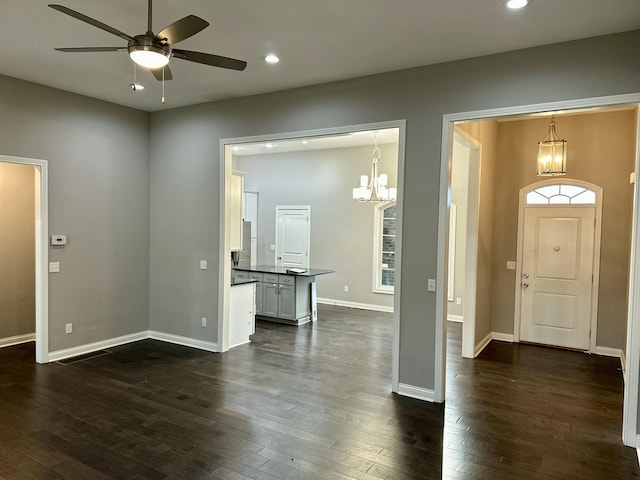 foyer entrance with recessed lighting, dark wood finished floors, baseboards, and ceiling fan with notable chandelier