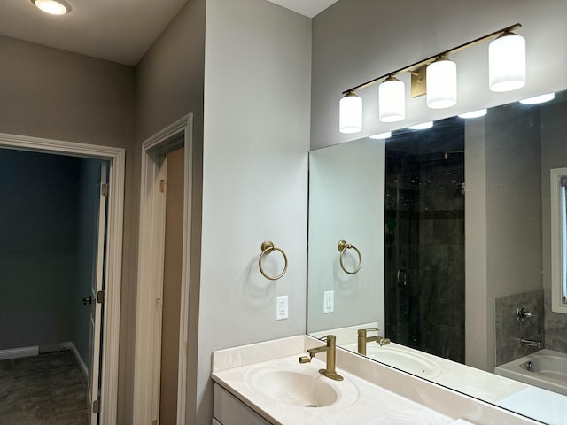 full bathroom featuring baseboards, a tile shower, a bath, and vanity