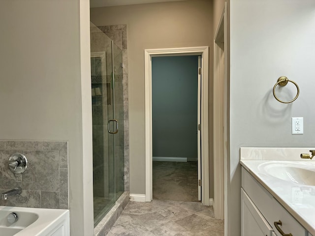 bathroom featuring a tub, a shower stall, and vanity