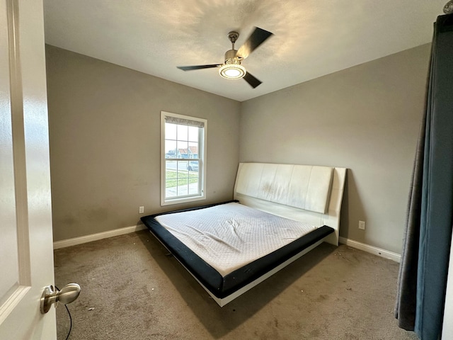 unfurnished bedroom featuring carpet flooring, ceiling fan, and baseboards