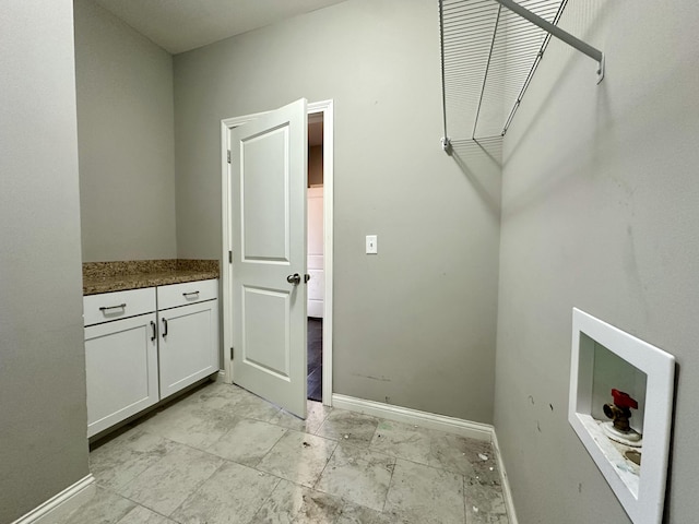 washroom with baseboards