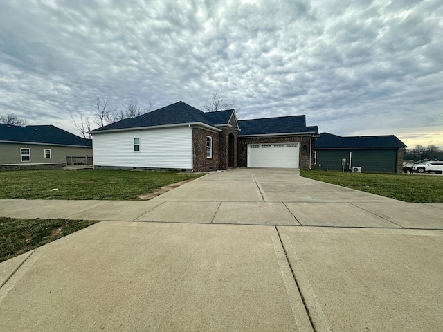 view of front of home featuring a garage, driveway, a front lawn, and brick siding