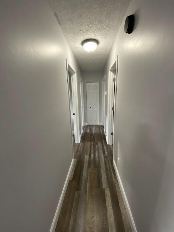 109 Homestead, London, KY 40741 - corridor with a textured ceiling, baseboards, and wood finished floors