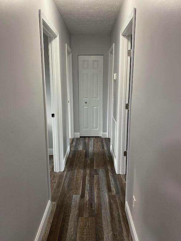 109 Homestead, London, KY 40741 - corridor with a textured ceiling, baseboards, and wood finished floors