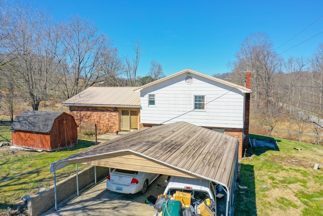 exterior space with a yard, a chimney, a storage unit, a carport, and an outdoor structure