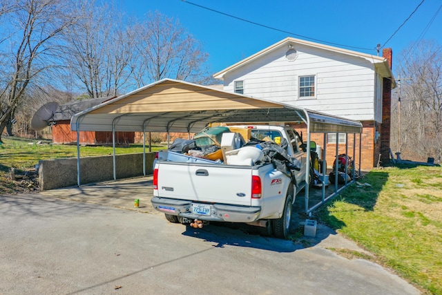 view of vehicle parking with a carport and aphalt driveway