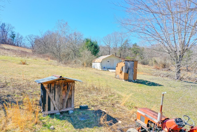 view of yard featuring an outbuilding and a shed