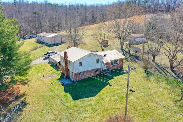 drone / aerial view featuring a wooded view