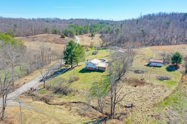 birds eye view of property featuring a forest view and a rural view