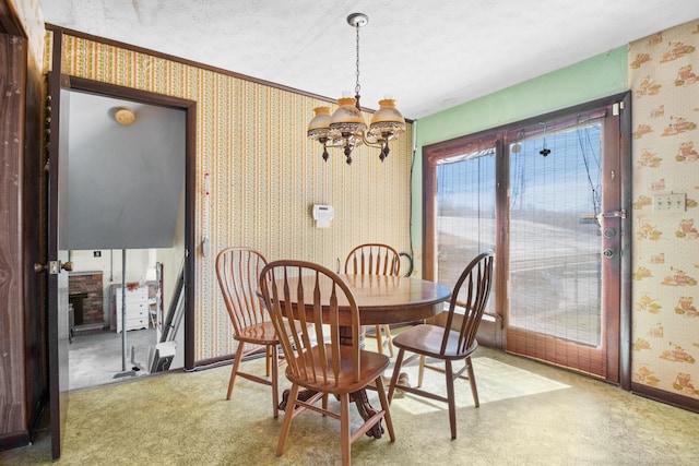 carpeted dining area with baseboards, a textured ceiling, a notable chandelier, and wallpapered walls