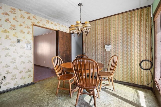 dining room featuring wallpapered walls, baseboards, and a notable chandelier