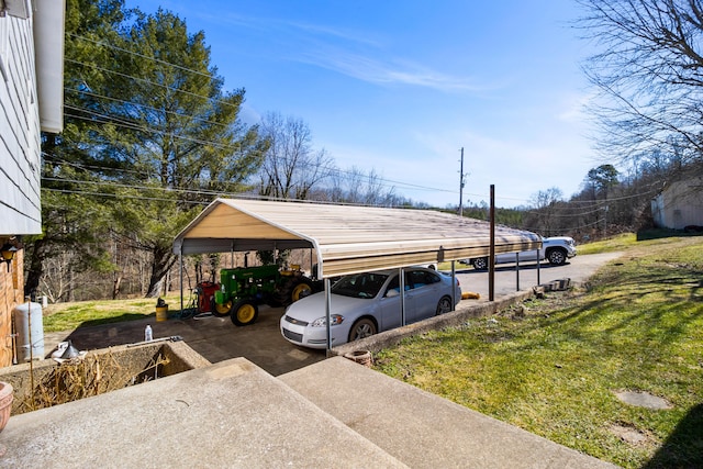 view of parking featuring a detached carport and concrete driveway