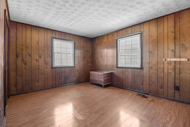 spare room featuring a textured ceiling and wood finished floors