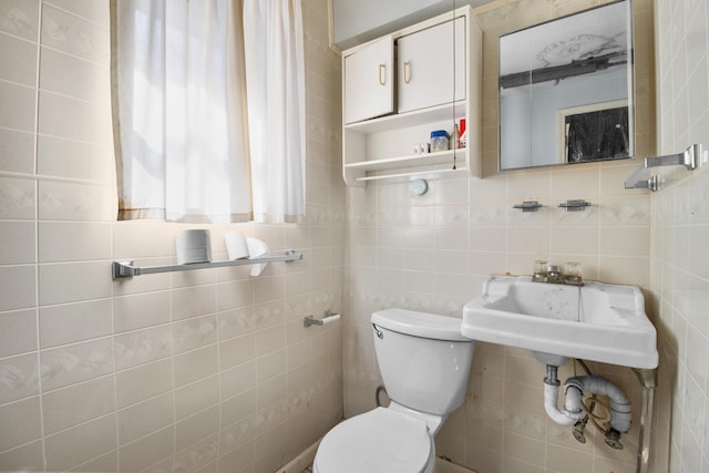 half bathroom with toilet and tile walls