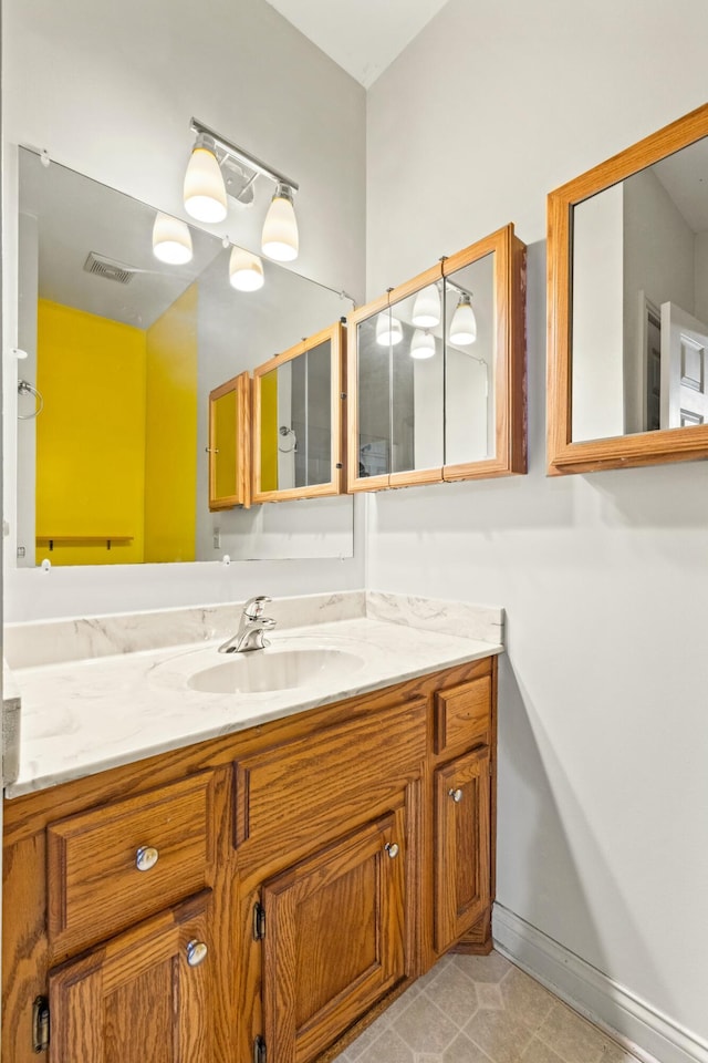 bathroom with baseboards, visible vents, and vanity