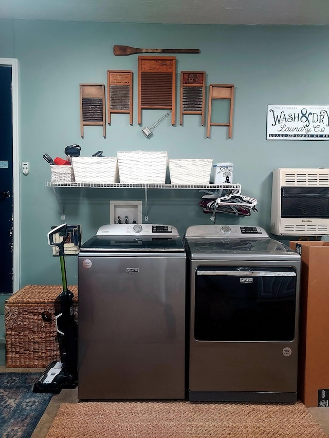 laundry room featuring laundry area, independent washer and dryer, and heating unit