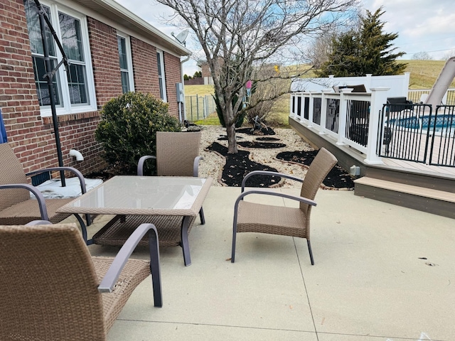 view of patio with fence and outdoor dining area