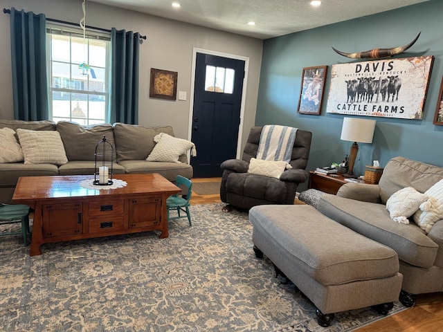 living area with a textured ceiling and recessed lighting