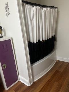 bathroom featuring baseboards and wood finished floors