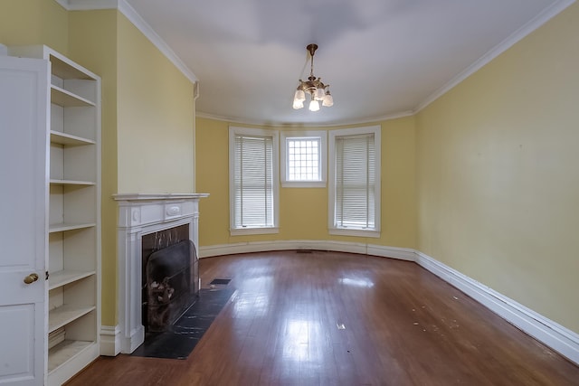 unfurnished living room featuring a fireplace with flush hearth, wood finished floors, visible vents, and crown molding