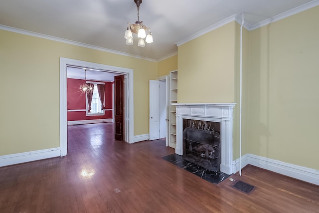 unfurnished living room with a chandelier, ornamental molding, a premium fireplace, and wood-type flooring