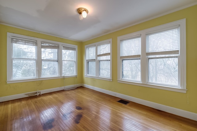 unfurnished sunroom with visible vents