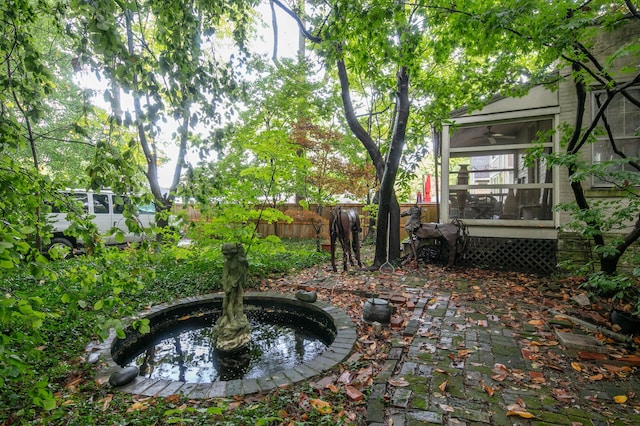 view of yard with a sunroom and fence