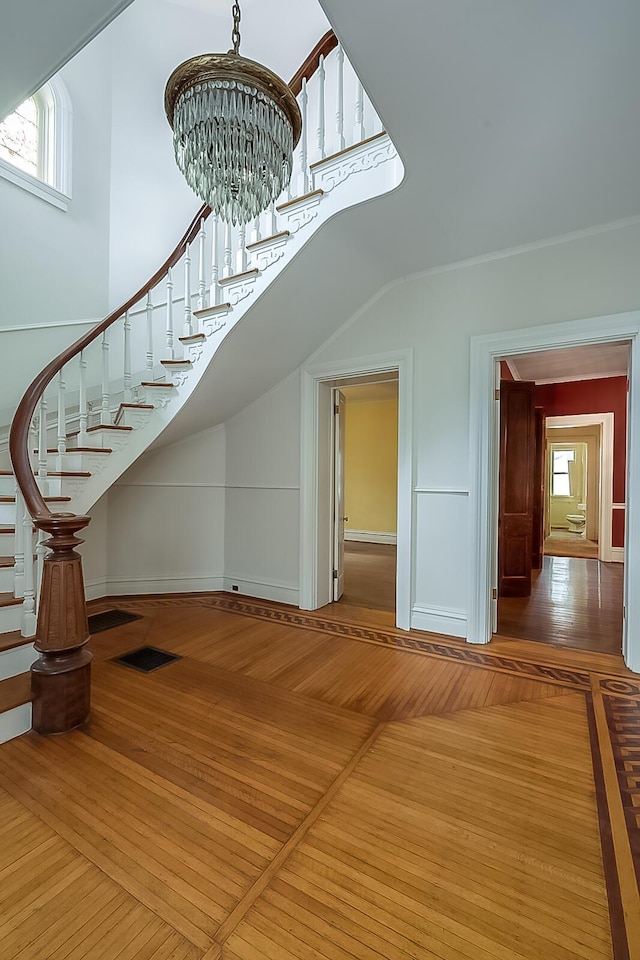 interior space featuring stairs, wood-type flooring, and a healthy amount of sunlight