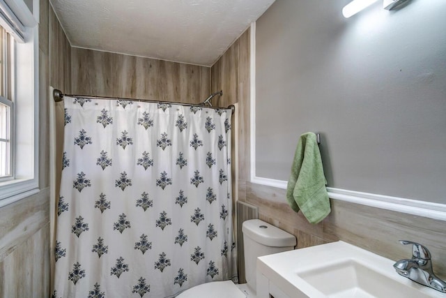 bathroom featuring tile walls, a shower with shower curtain, toilet, a textured ceiling, and vanity