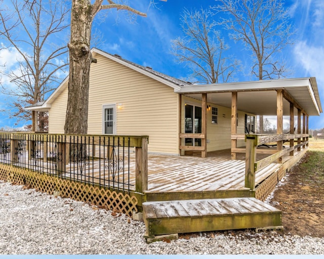 back of property with a wooden deck