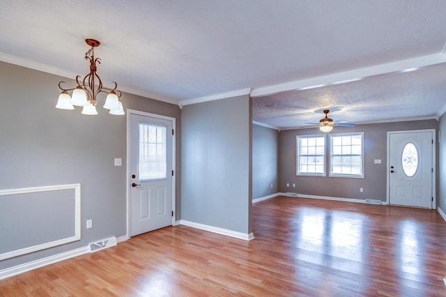 entryway featuring baseboards, light wood-type flooring, visible vents, and crown molding