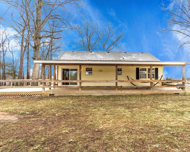 back of property featuring a yard and a wooden deck