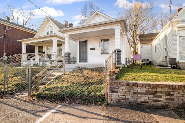 view of front of house featuring a porch, a gate, and a fenced front yard