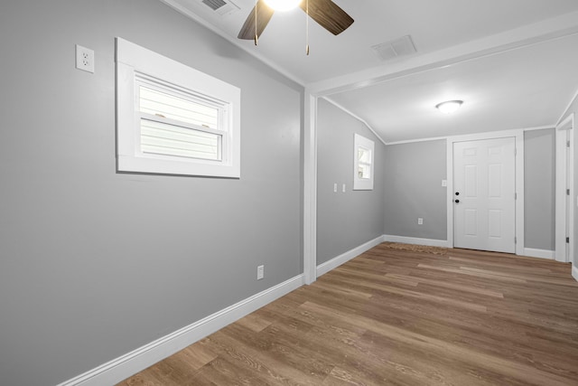 empty room featuring visible vents, wood finished floors, and baseboards