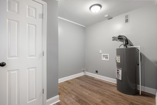 clothes washing area with visible vents, electric water heater, dark wood finished floors, washer hookup, and laundry area