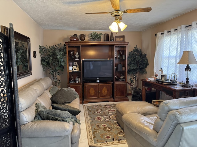 tiled living area featuring a textured ceiling and a ceiling fan