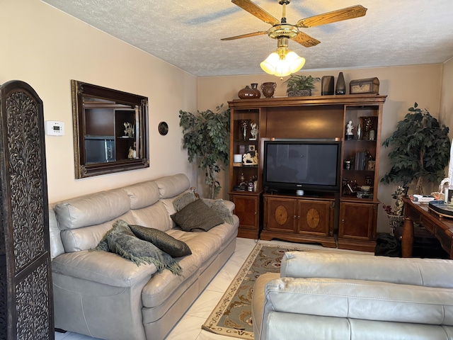 living area with a textured ceiling and a ceiling fan