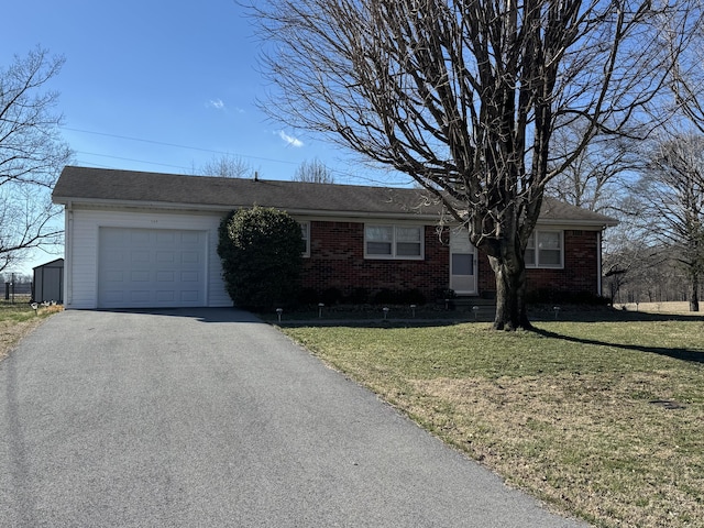 ranch-style home with brick siding, driveway, a front yard, and a garage