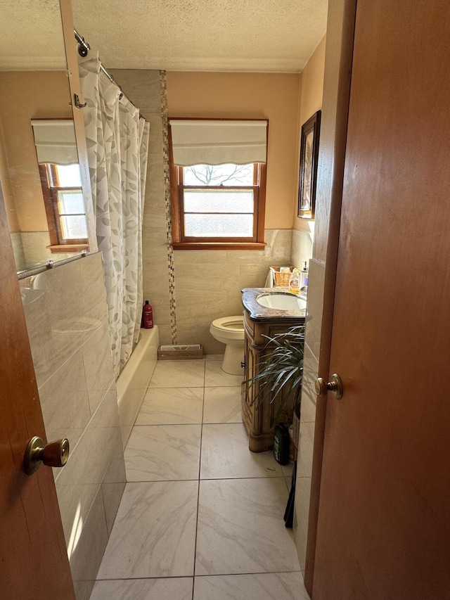149 Cherokee Ave, Russell Springs, KY 42642 - full bath featuring healthy amount of natural light, a textured ceiling, toilet, marble finish floors, and vanity