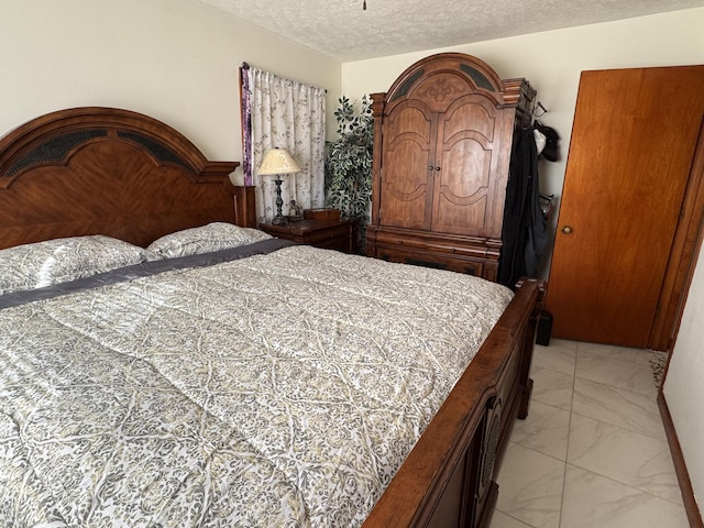 149 Cherokee Ave, Russell Springs, KY 42642 - bedroom with light marble finish flooring and a textured ceiling
