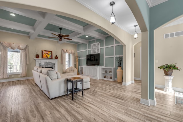 living area featuring light wood-style flooring, coffered ceiling, a high end fireplace, visible vents, and beam ceiling