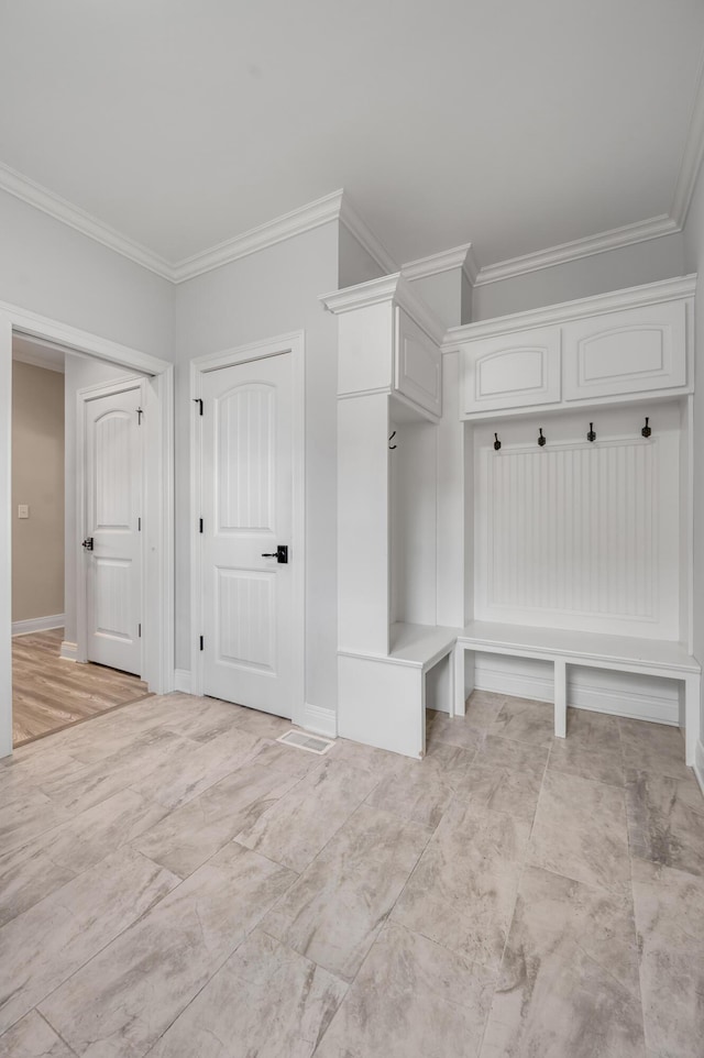 mudroom with baseboards and crown molding