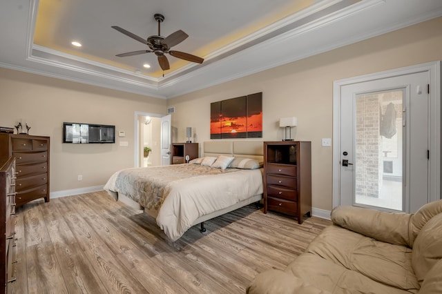 bedroom featuring baseboards, a raised ceiling, ornamental molding, wood finished floors, and recessed lighting