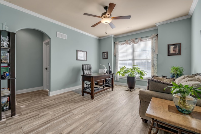 office featuring arched walkways, light wood finished floors, visible vents, and ornamental molding