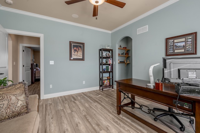 home office featuring baseboards, visible vents, light wood-style flooring, ceiling fan, and crown molding